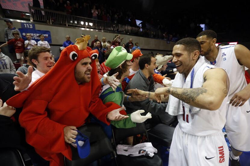 SMU fans greet Southern Methodist player Nic Moore (11) after their men's NCAA college...
