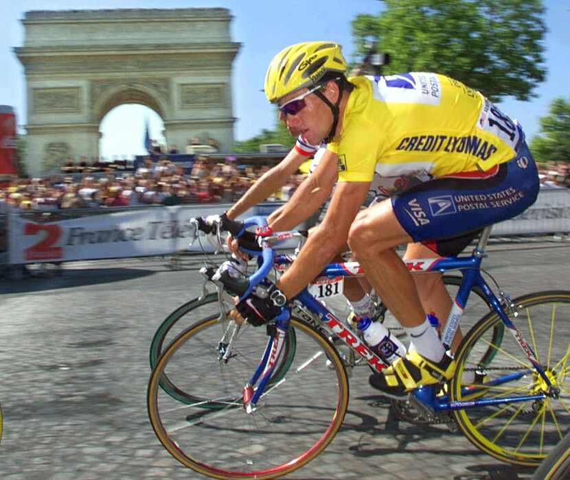 Overall leader Lance Armstrong of the U.S. rides past the Arc de Triomphe during the 20th...