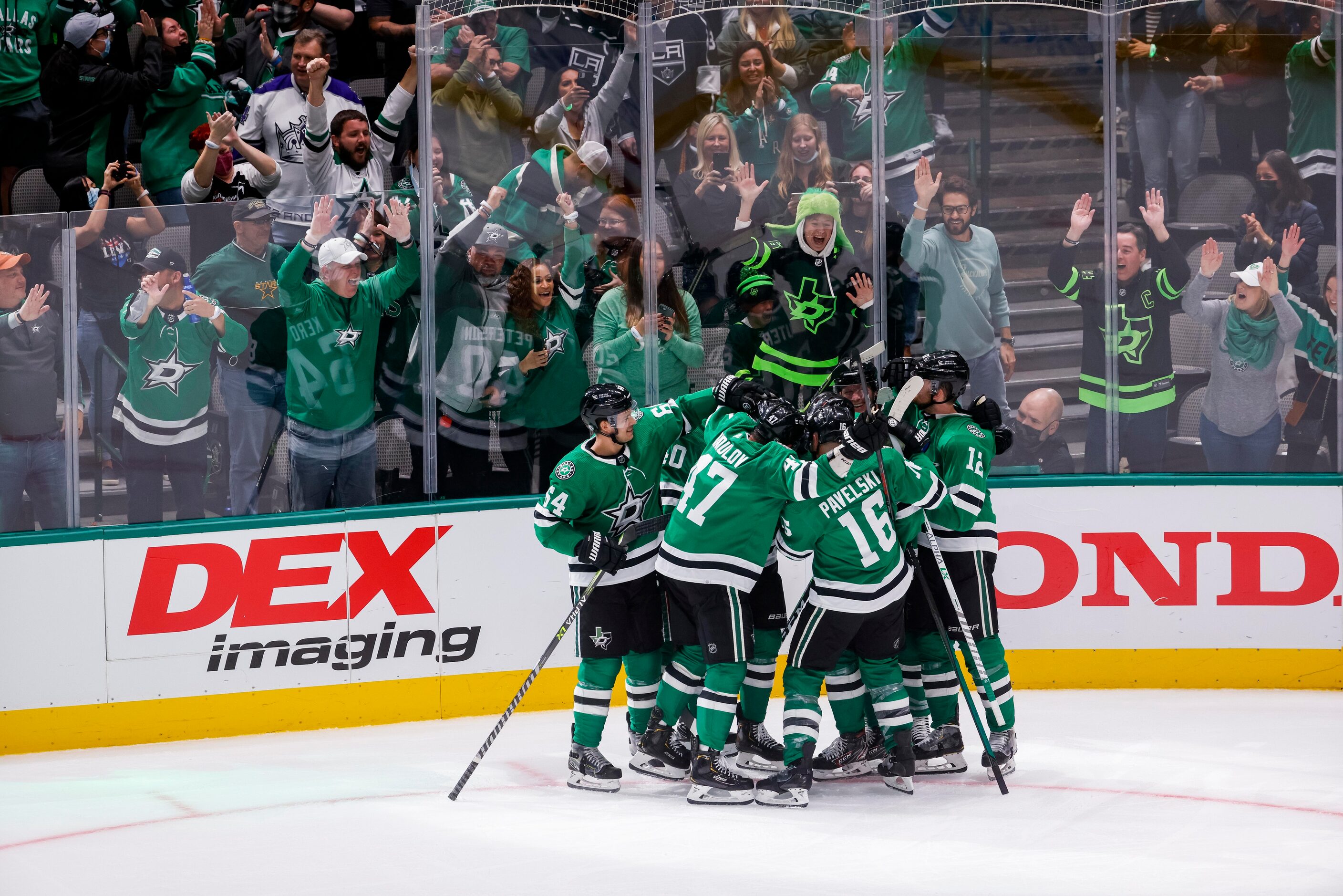 Dallas Stars right wing Denis Gurianov (34) teammates after hitting the game winning puck...