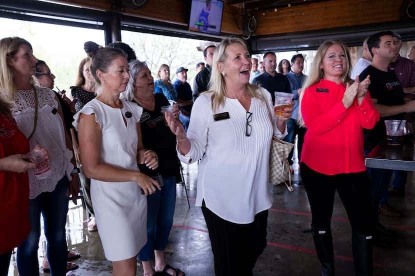 Realtor Bridget Andrew celebrates winning a prize during a Fathom Realty happy hour on Aug....
