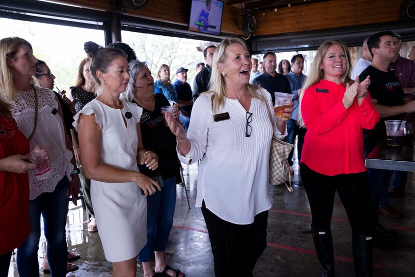 Realtor Bridget Andrew celebrates winning a prize during a Fathom Realty happy hour on Aug....