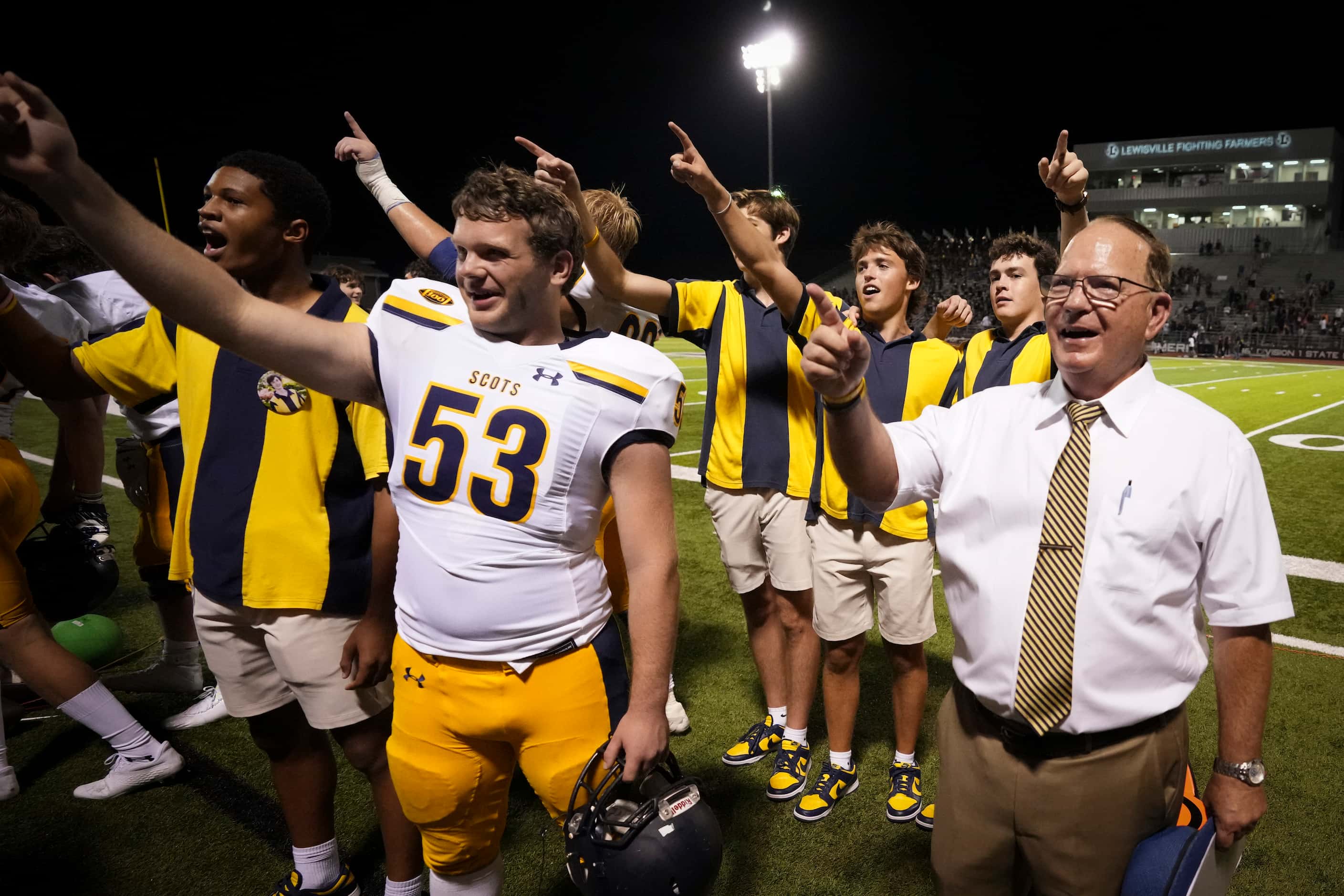 Highland Park head coach Randy Allen stands for the school song with offensive lineman Paul...