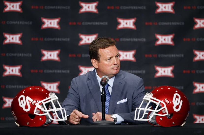 FILE - Oklahoma head football coach Bob Stoops listens to a question posed by a reporter...