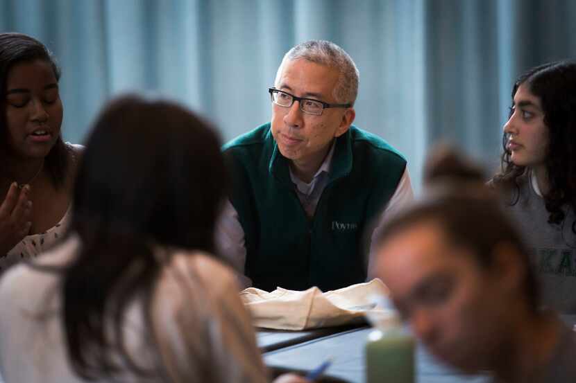 Tom Huang of The Dallas Morning news works with high school students participating in the...