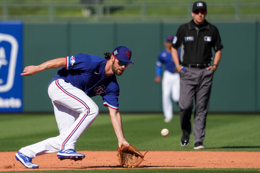 Texas Rangers infielder Charlie Culberson makes a play at shortstop during the eighth inning...