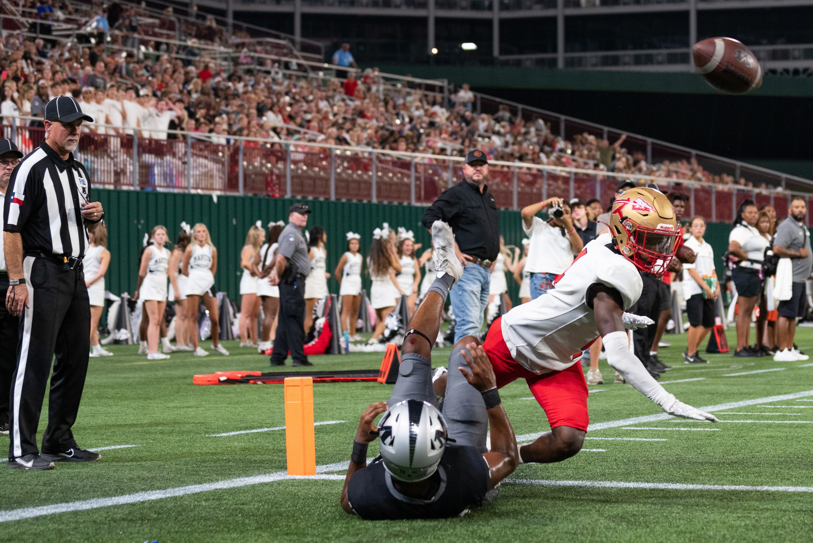 Arlington Martin senior wide receiver Ismael Smith Flores (15) is hit before having a chance...