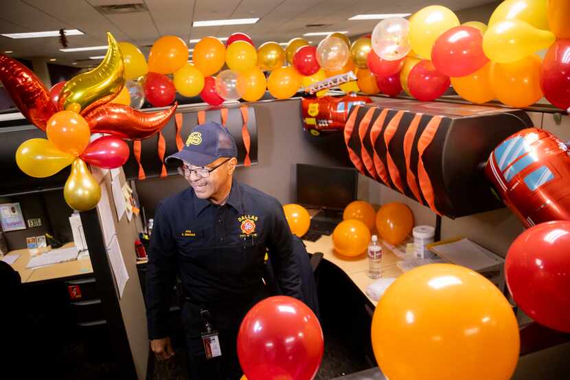 Fire prevention officer Clarence Briggs stops at his desk, which was decorated as part of a...