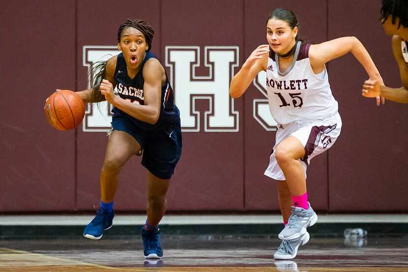 Sachse's Tia Harvey (12) brings the ball up the floor against Rowlett's Madi Rodriguez (15)...