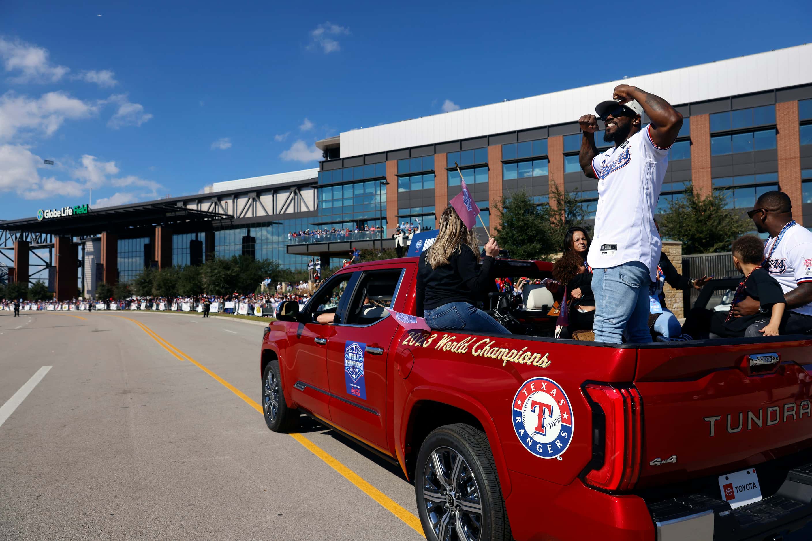 Texas Rangers right fielder Adolis Garcia flexes his muscles for fans during the World...