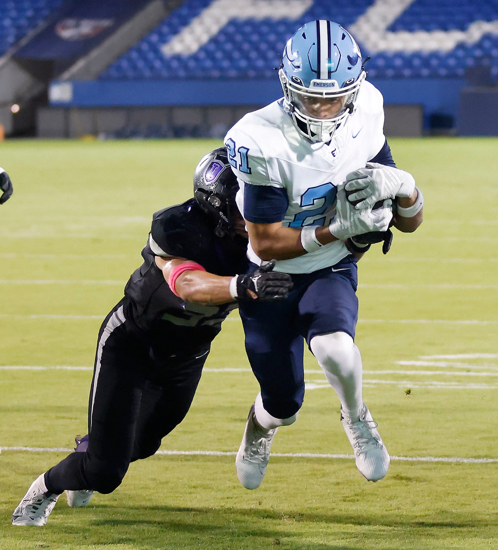 Frisco Emerson running back Persha Allen (21) drags Frisco Independence linebacker Gianni...