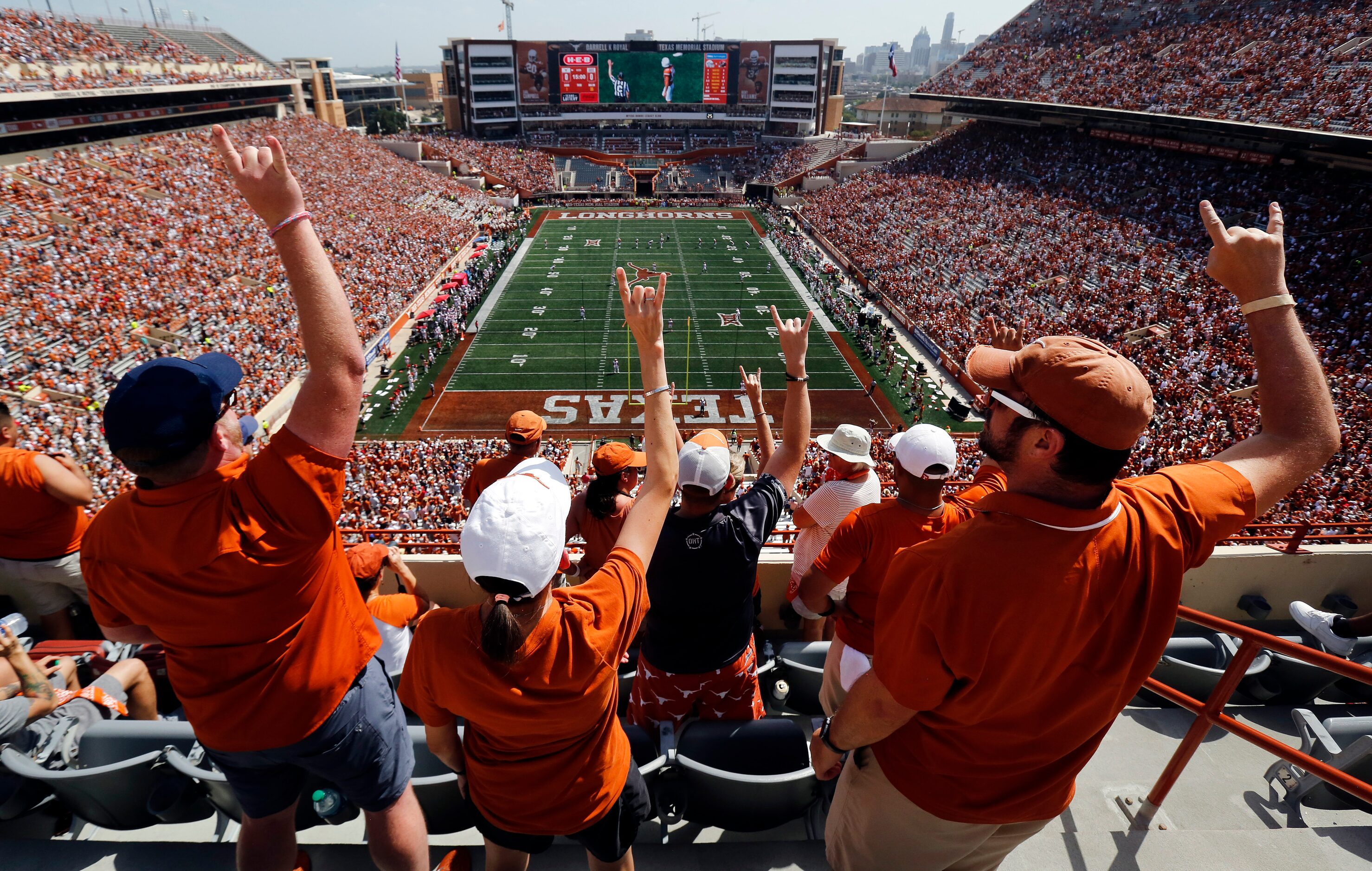 Texas Longhorns fans raise their Hook'em Horns hands as they prepare to kickoff the season...