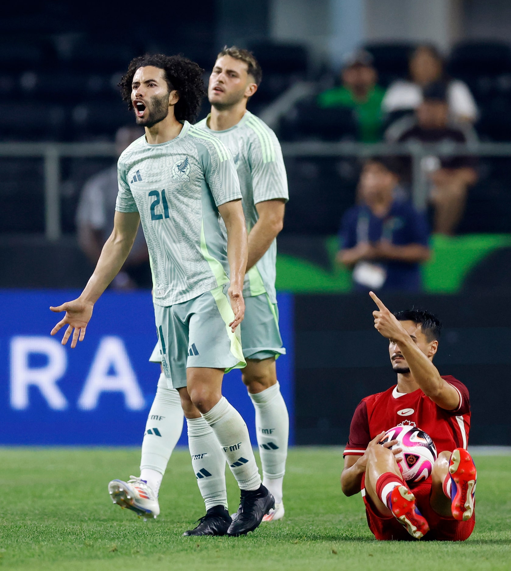 Mexico midfielder Cesar Huerta (21) reacts after being called for a foul on Canada...