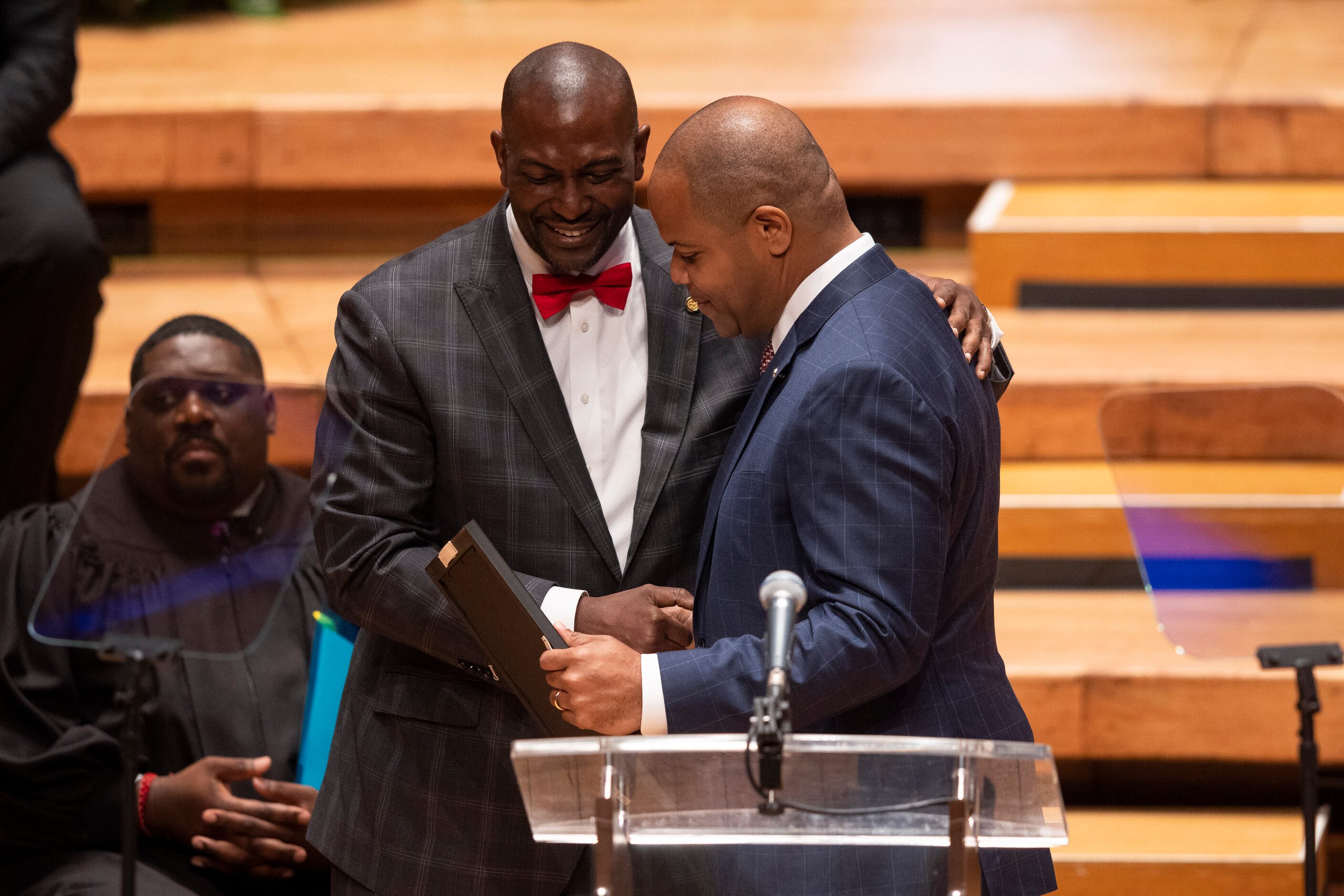 Outgoing city council member Casey Thomas is recognized by Dallas Mayor Eric Johnson during...