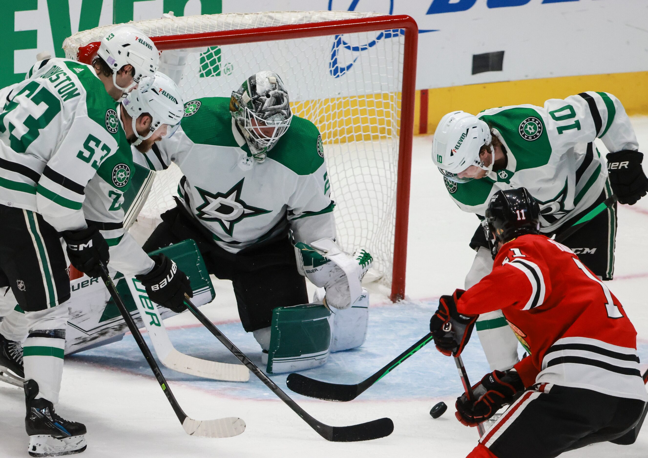 The puck rebounds from Dallas Stars goaltender Jake Oettinger (29) moments before Chicago...