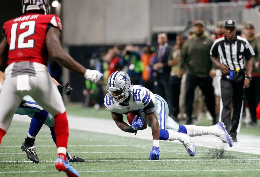 FILE - Cowboys safety Xavier Woods (25) intercepts a pass during the first half of a game...