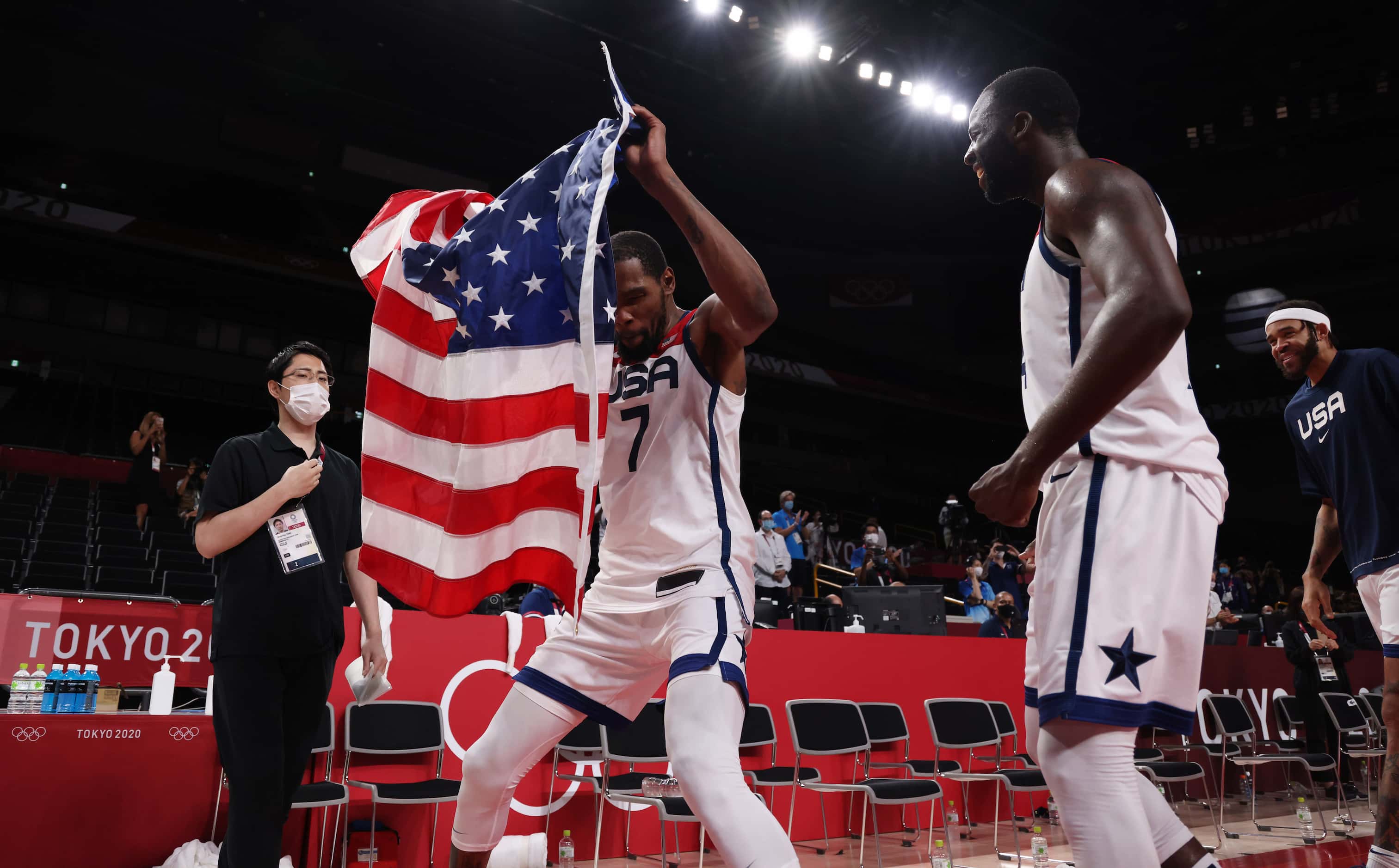 USA’s Kevin Durant (7) and Draymond Green (14) celebrate with teammates after defeating...