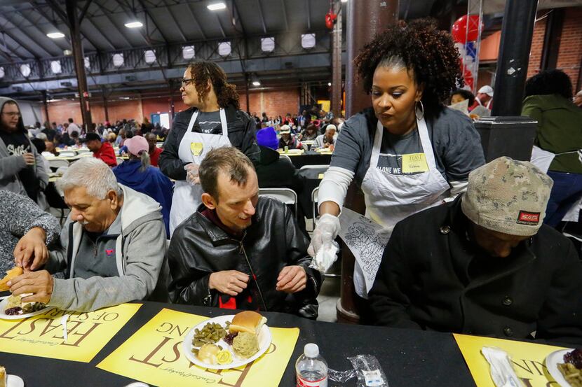 Jonathan Hale (center) was served a full Thanksgiving meal from volunteer Valerie Walter at...