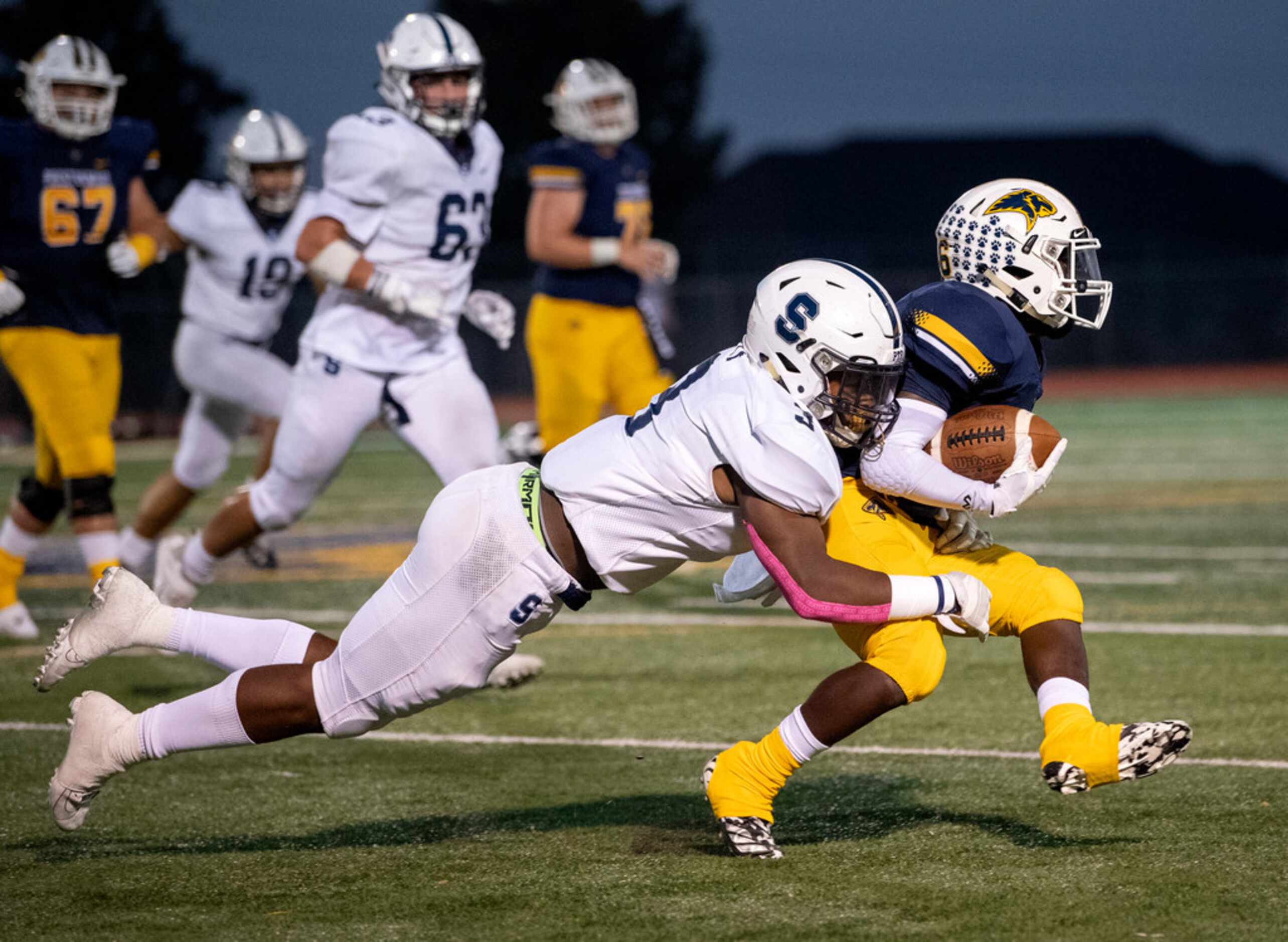 Fort Worth All Saints senior linebacker Caimyn Layne (3) takes down Plano Prestonwood...