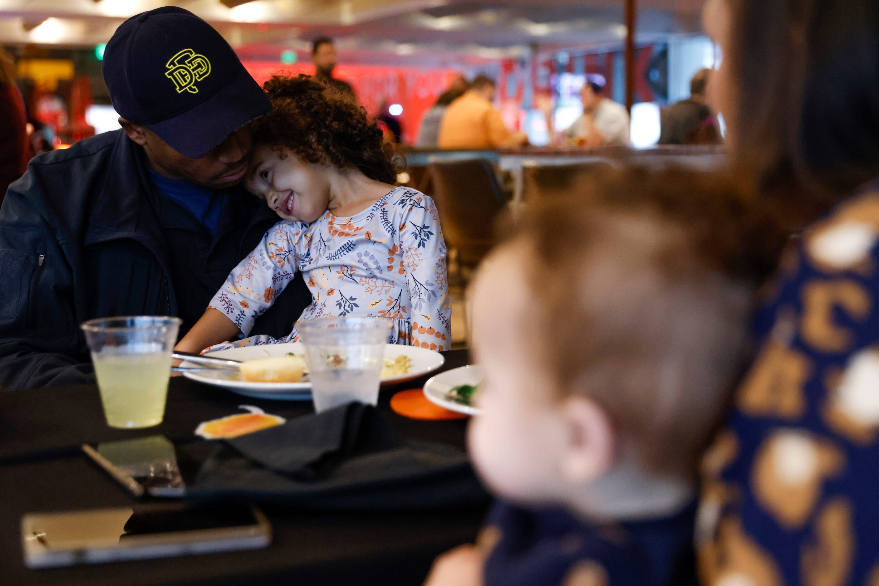 Jahmal Hall, left, with the Dallas Fire Department, engages with his daughter Christian, 3,...