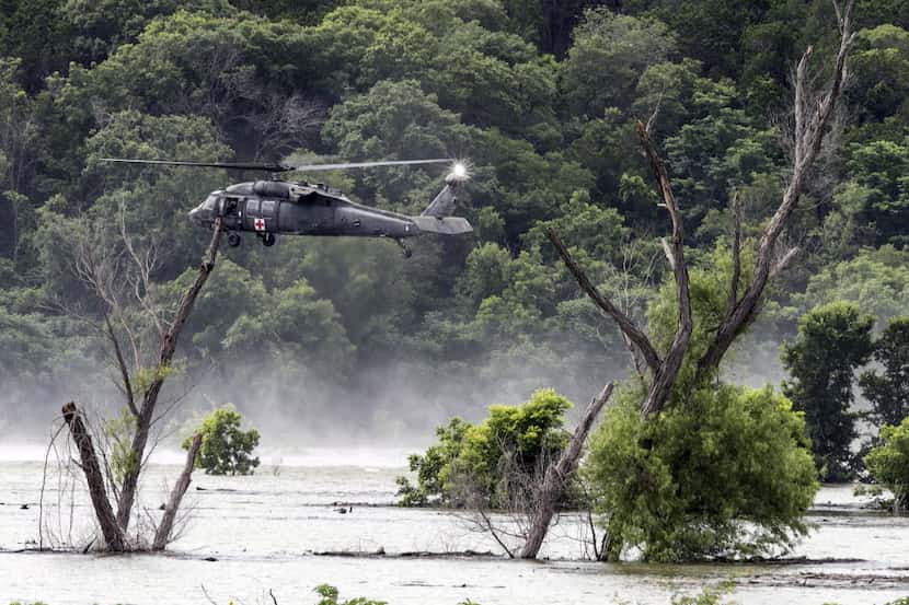 Army helicopters hover above Lake Belton Friday, June 3, 2016, searching for four missing...