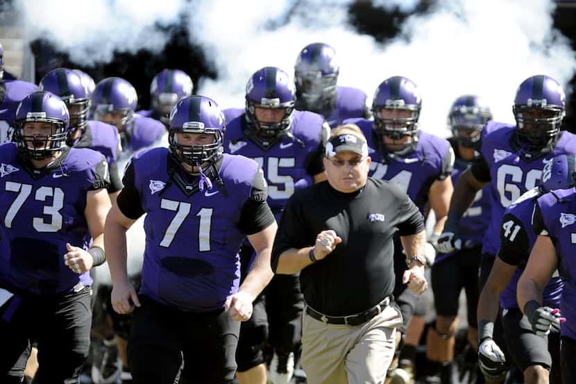 In this photo taken Saturday, Oct. 1, 2011, TCU head coach Gary Patterson runs onto the...