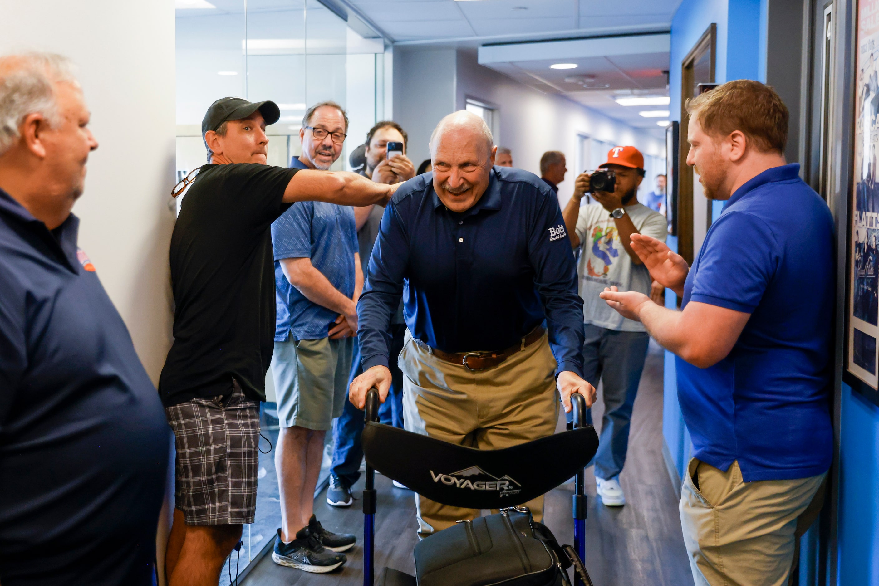 Local sports radio legend Norm Hitzges reacts as he walks through a honor walk after his...