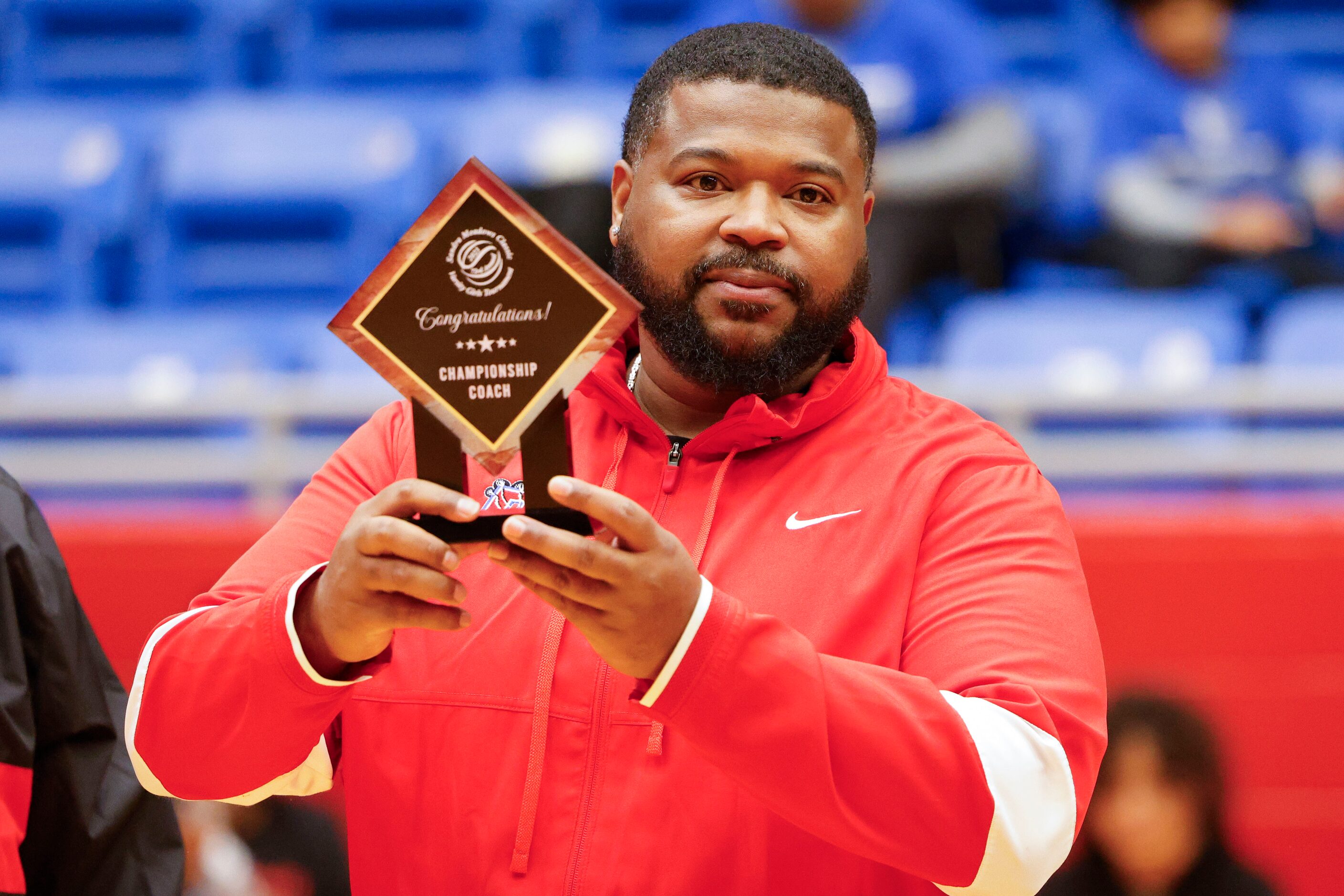 Duncanville high girls basketball coach Neiman Ford receives the trophy for Championship...