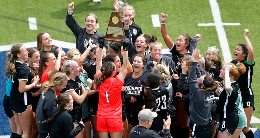 Prosper players revel in the moment with their regional trophy on the field after defeating...