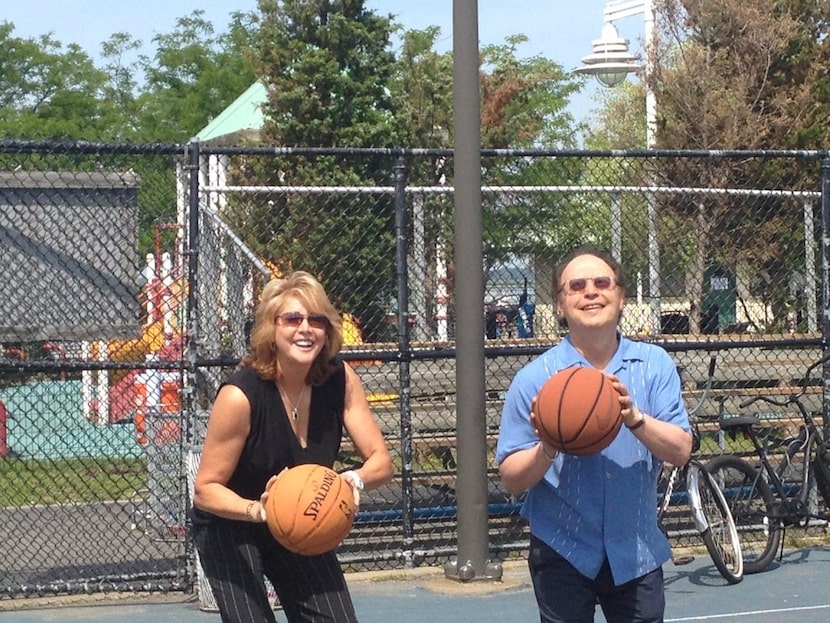 Basketball legend Nancy Lieberman and comedian Billy Crystal prepare for a shot at the...