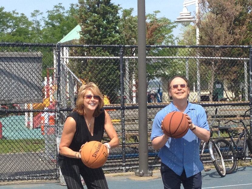 Basketball legend Nancy Lieberman and comedian Billy Crystal prepare for a shot at the...