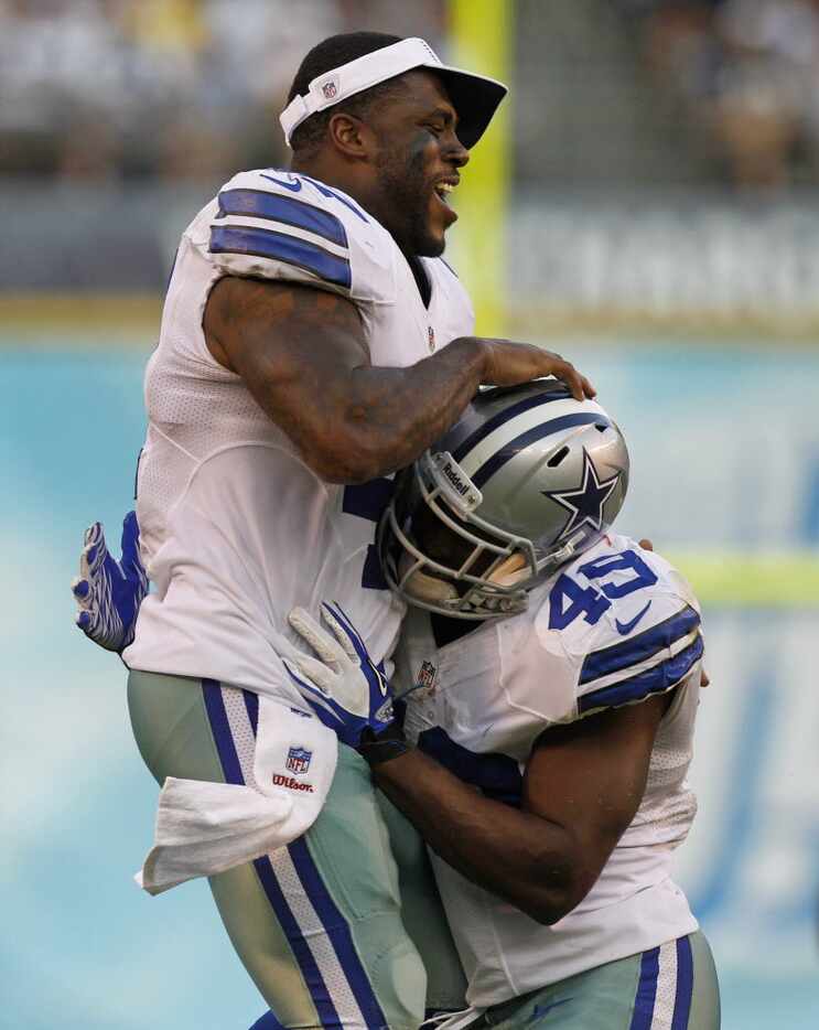 Dallas Cowboys wide receiver Dwayne Harris (17) jumps on Dallas  back Jamize Olawale (49)...