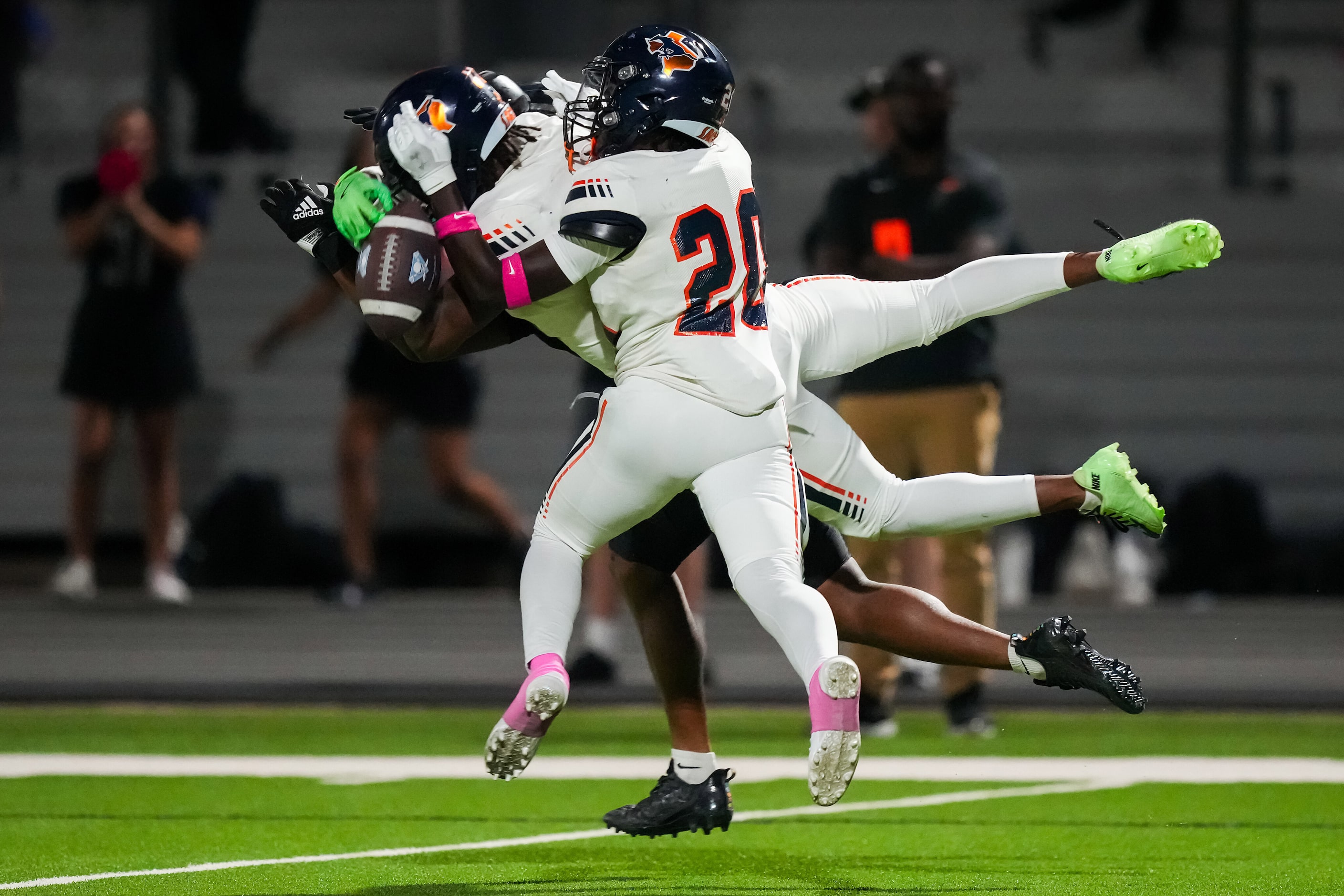 Sachse defensive back Cory Taylor (20) and defensive back CJ Wells (17) break up a pass...