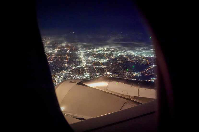 The lights of Dallas are seen from a flight on approach for DFW Airport on Saturday, Feb. 3,...