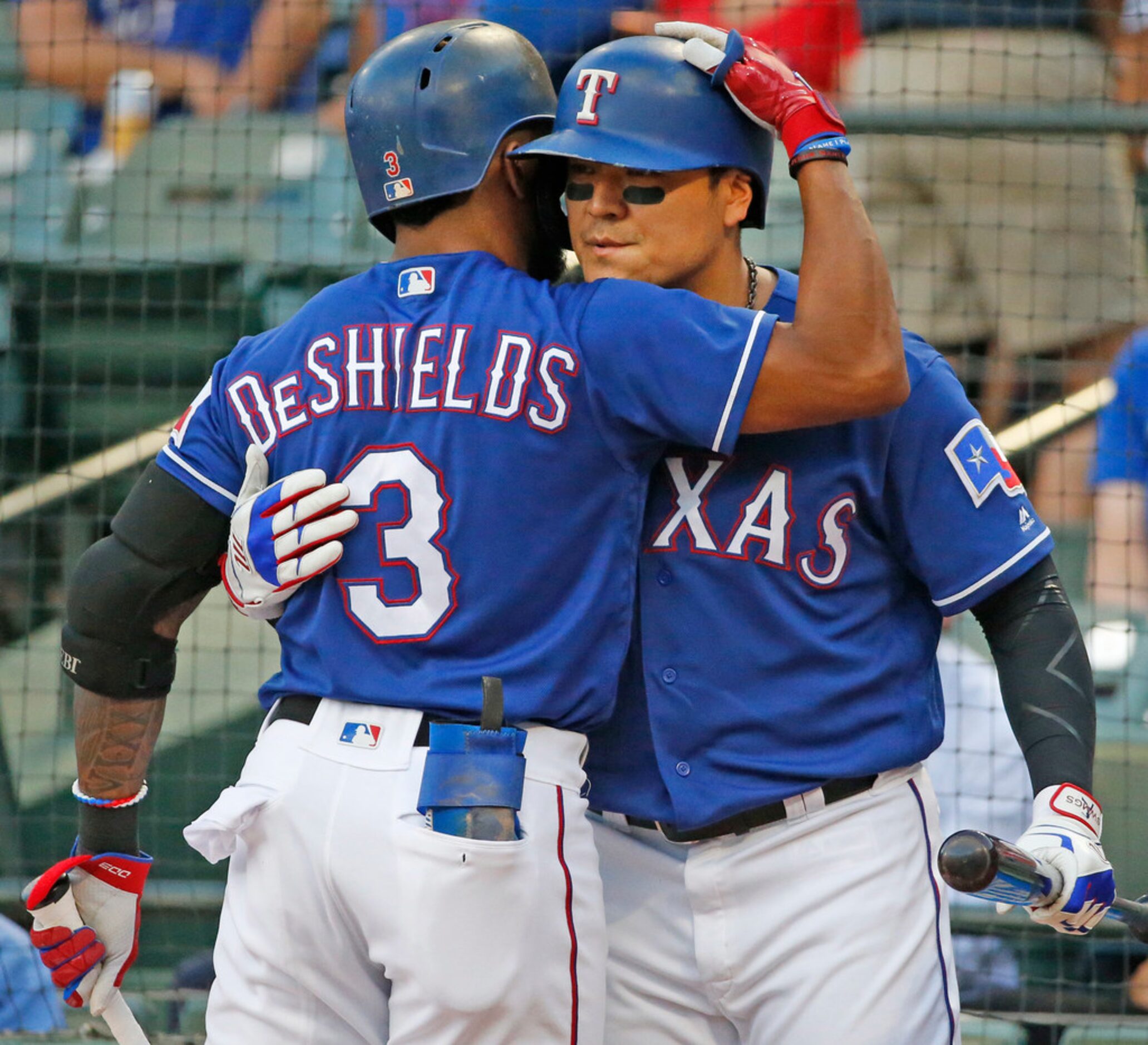 Texas Rangers outfielders Delino DeShields (3) and Shin-Soo Choo (17)embrace before their at...