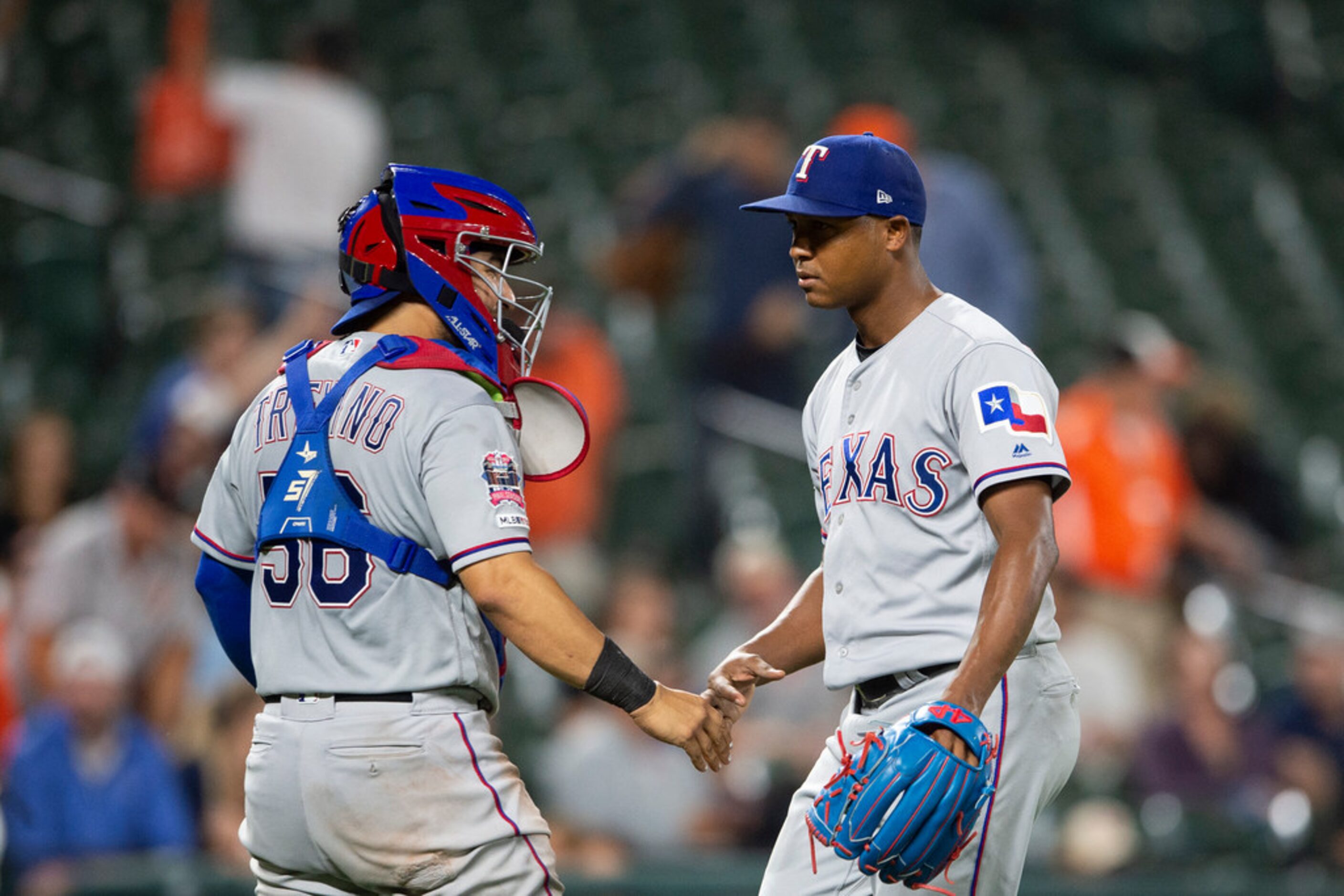 Texas Rangers' Jose Trevino, left, and Jose Leclerc talk after the team's baseball game...