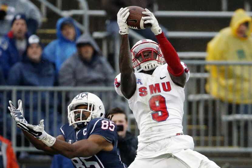 SMU defensive back Horace Richardson (9) intercepts the pass intended for Connecticut wide...