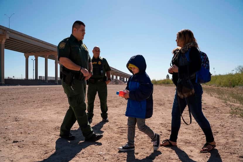 A mother and her son turn themselves in to US Border Patrol agents to claim asylum after...