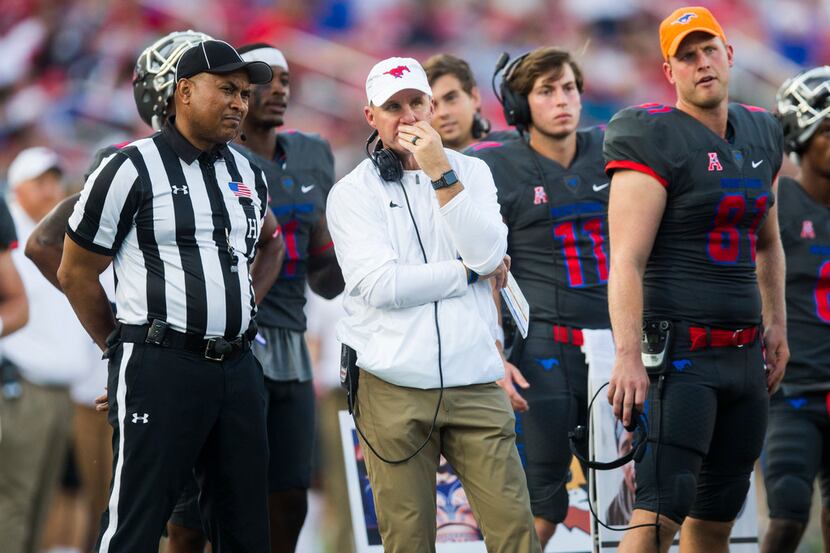 Southern Methodist Mustangs head coach Chad Morris, center, watches as a touchdown play is...