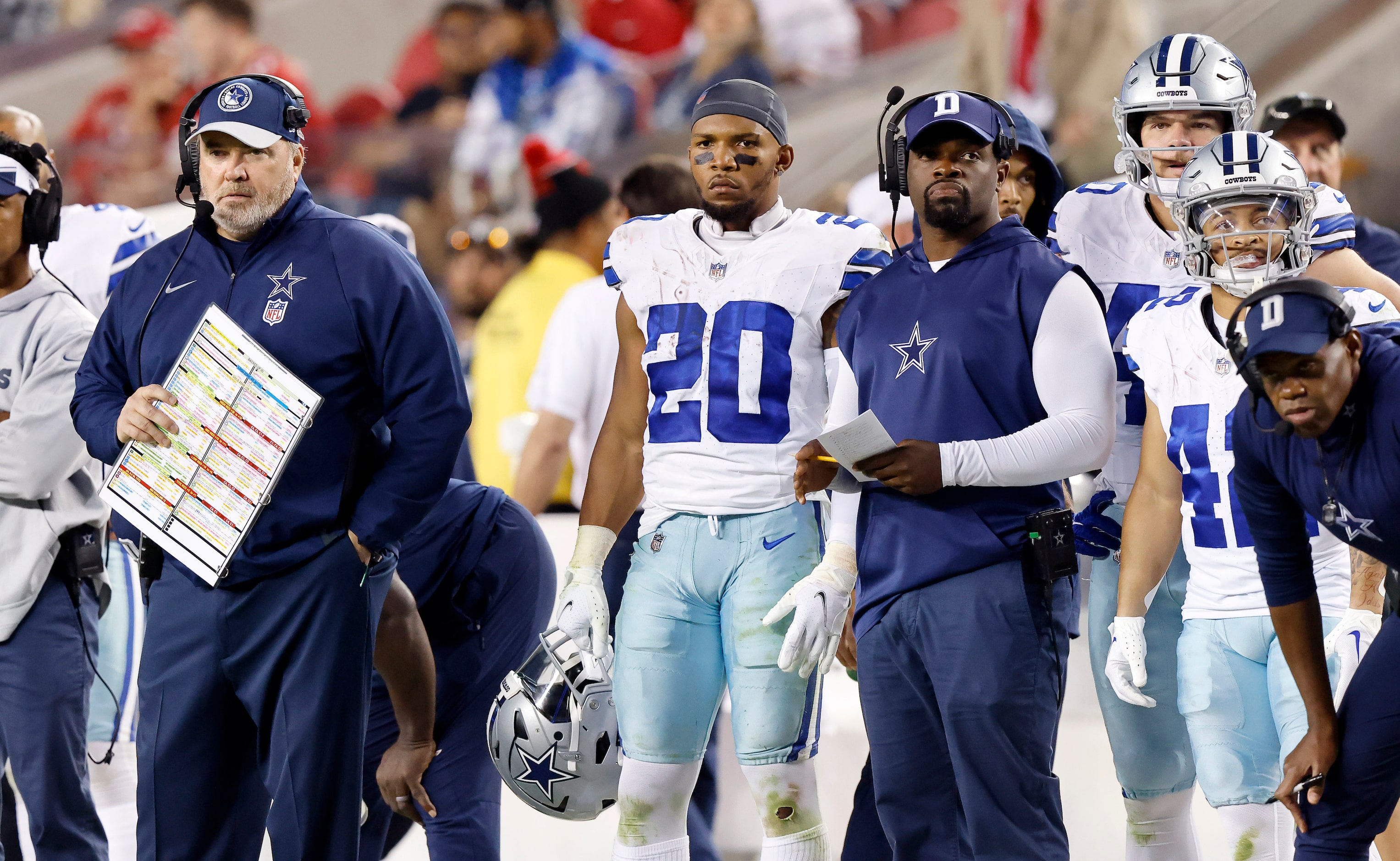 Dallas Cowboys head coach Mike McCarthy and  running back Tony Pollard (20) watch from the...