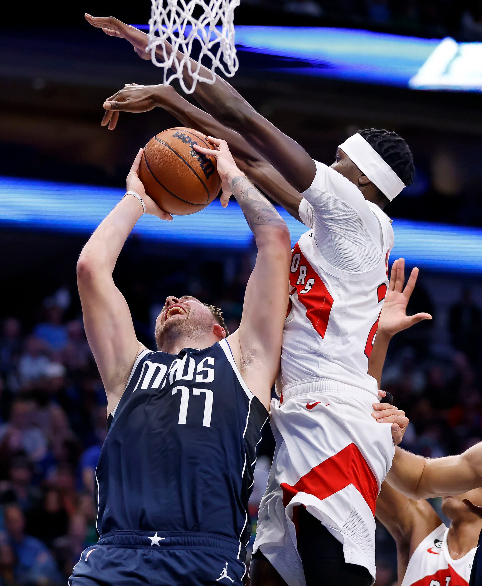 Dallas Mavericks guard Luka Doncic (77) is fouled by Toronto Raptors forward Chris Boucher...