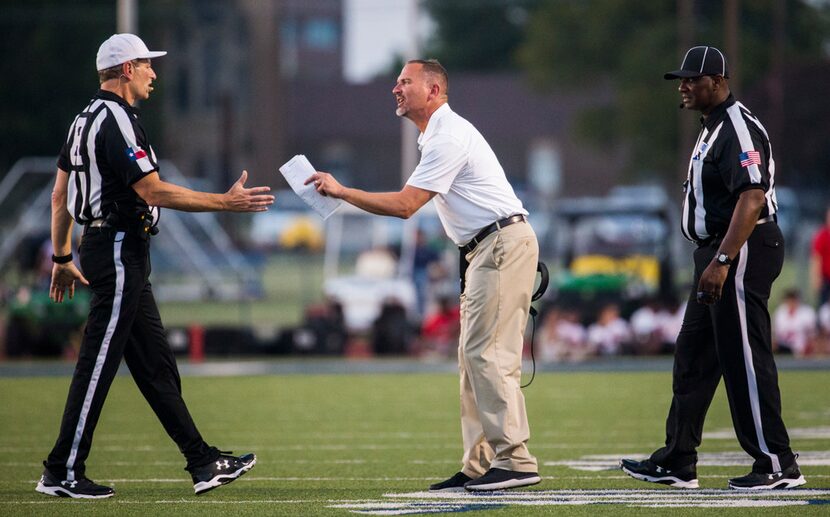 McKinney Boyd head coach Don Drake disputes a call with officials after a penalty was called...