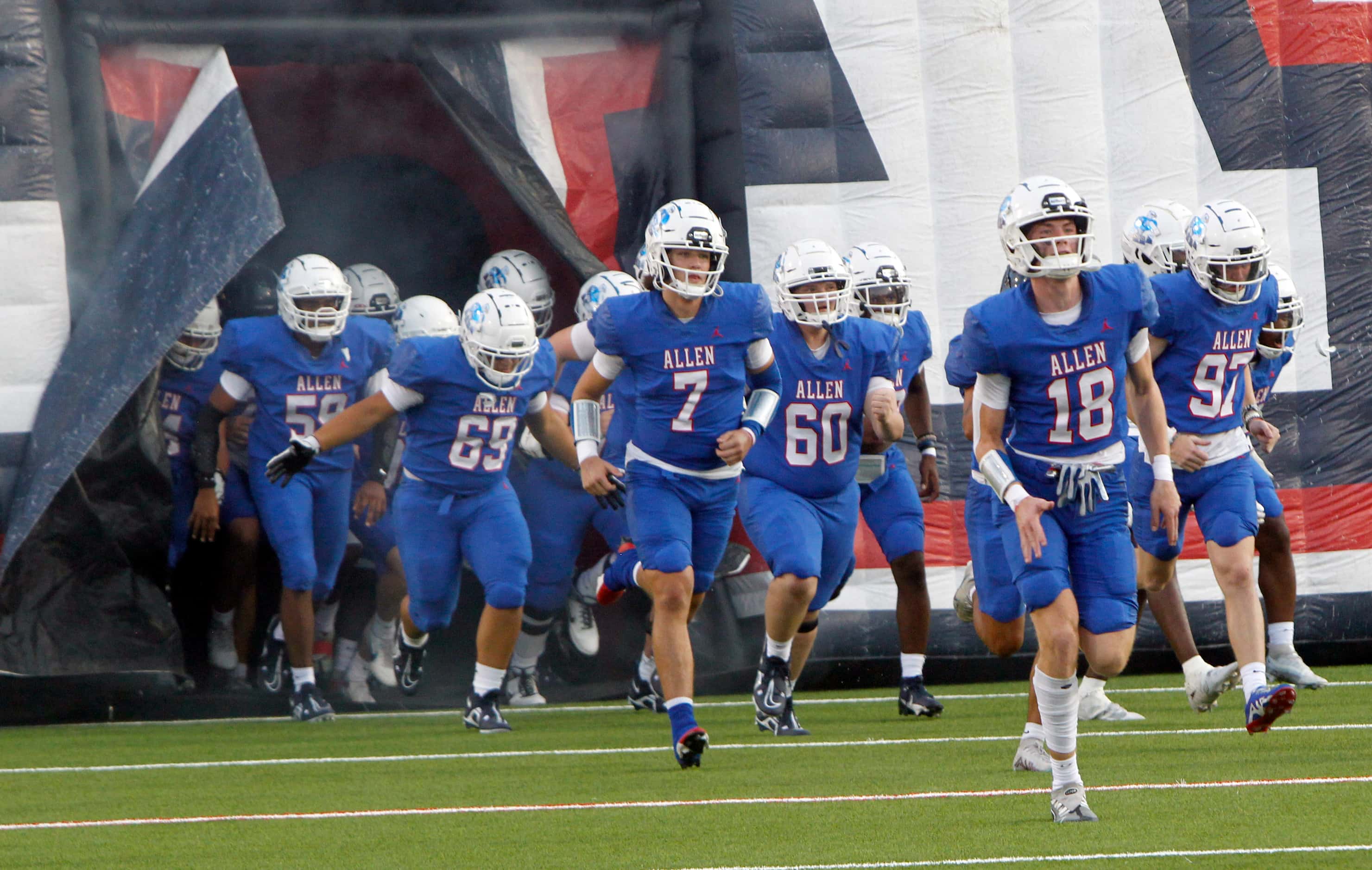 Allen Eagles players emerge from the team inflatable prior to the opening kickoff against...