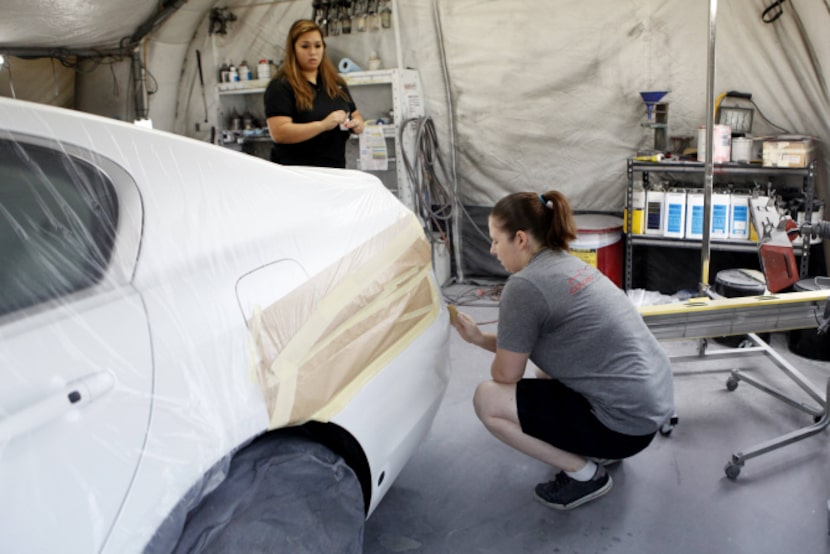 Shop manager Thy Dam (left) and Stephanie Milne attend to details on a repair. Owner Tim...