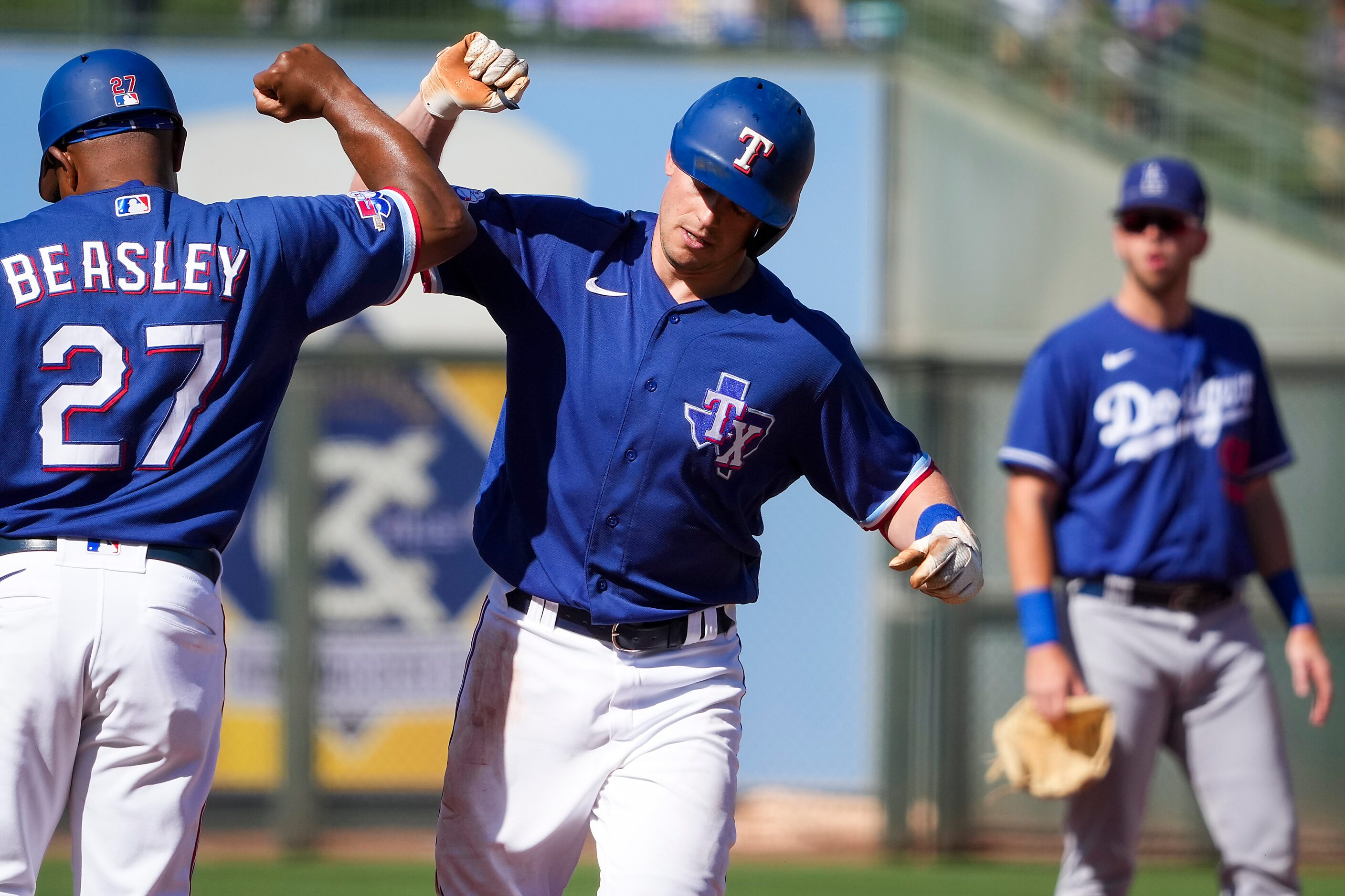 Texas Rangers left fielder Nick Solak celebrates with third base coach Tony Beasley as he...