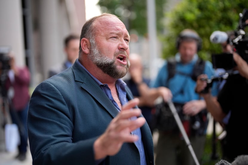 Alex Jones speaks to the media after arriving at the federal courthouse for a hearing in...