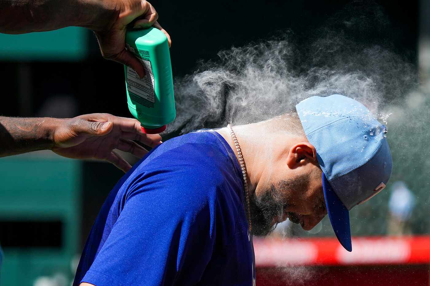 Texas Rangers starting pitcher Martin Perez is doused with body powder by right fielder...