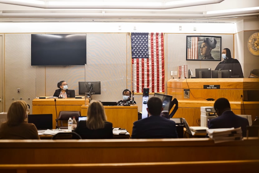 State District Judge Amber Givens talks to Dallas Police Detective Christine Ramirez while...