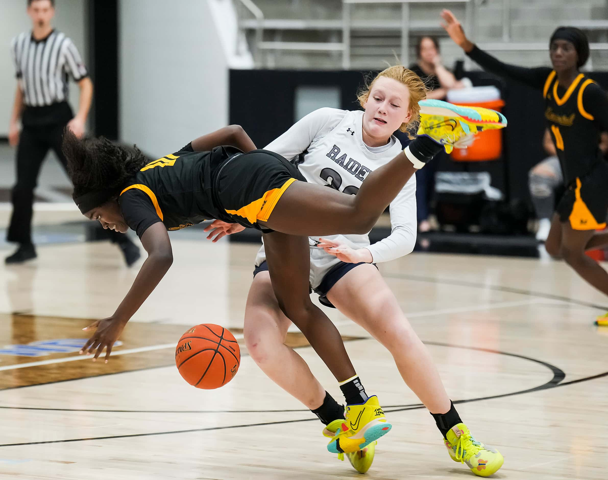 Frisco Memorial's Jasmyn Lott (10) is fouled by Wylie East's Kerbie Cash (23) during the...