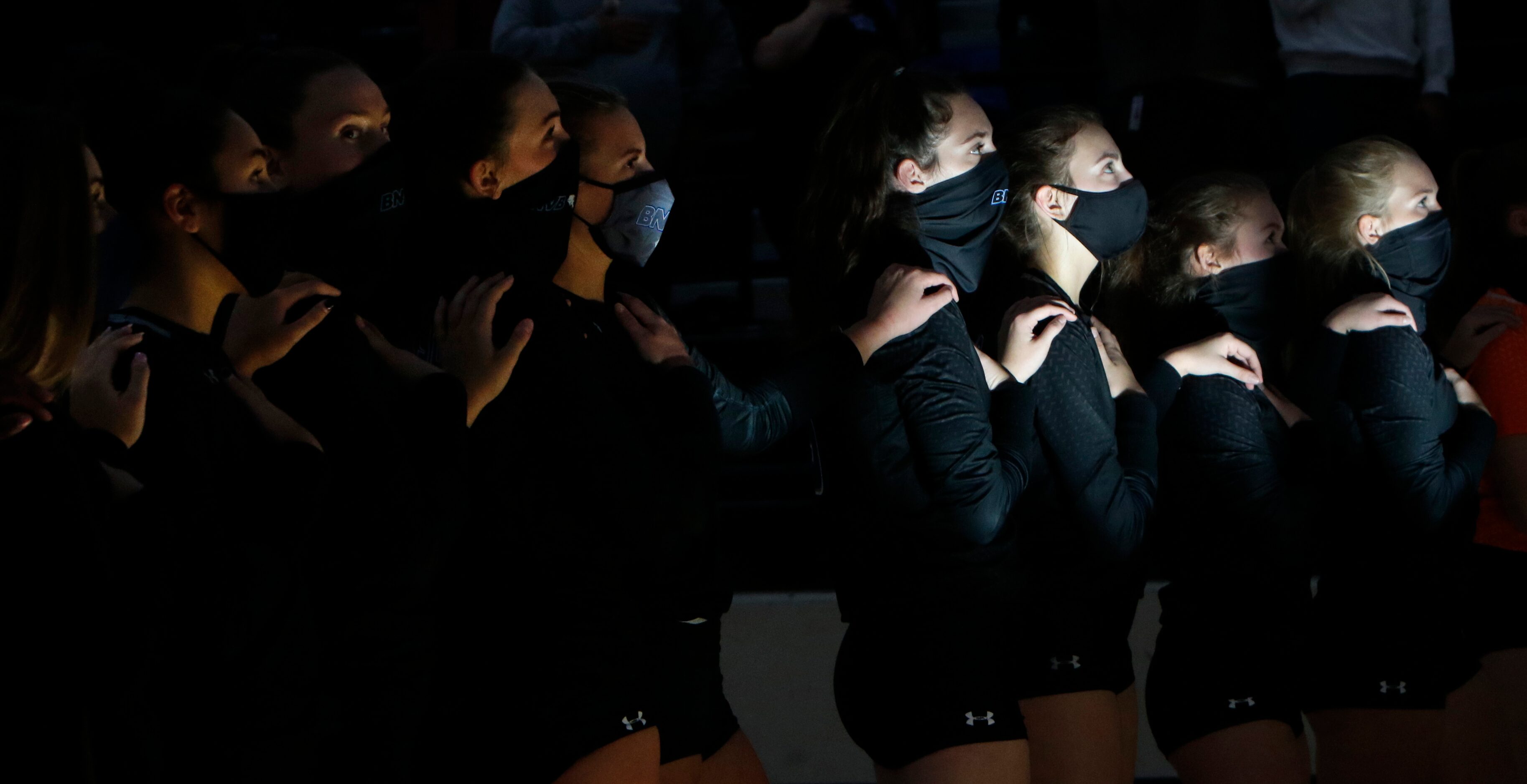 A ray of sunlight illuminates a few of the Trophy Club Byron Nelson players as they pause...