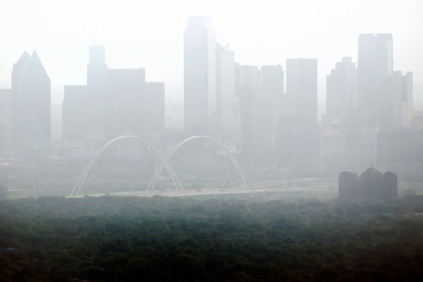 The Dallas skyline is seen through hazy skies as a dust plume, which traveled from the...
